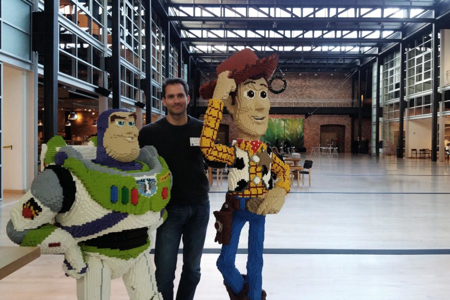 Scott Eaton at Pixar, in atrium with Lego Buzz and Woody